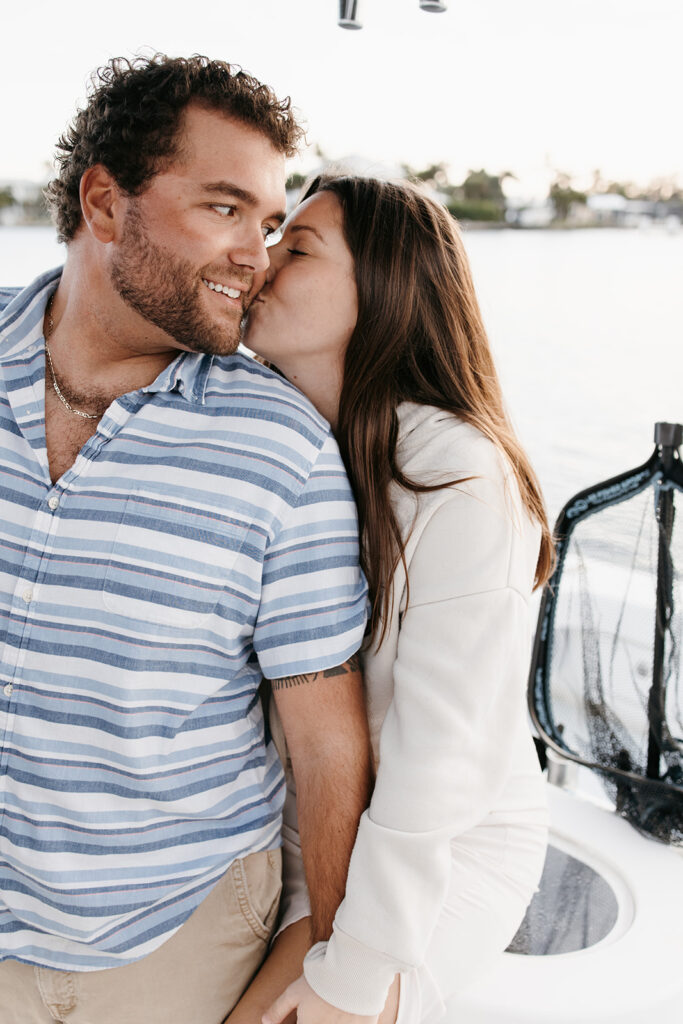 couple sitting together on man's fishing boat in Florida for their engagement session