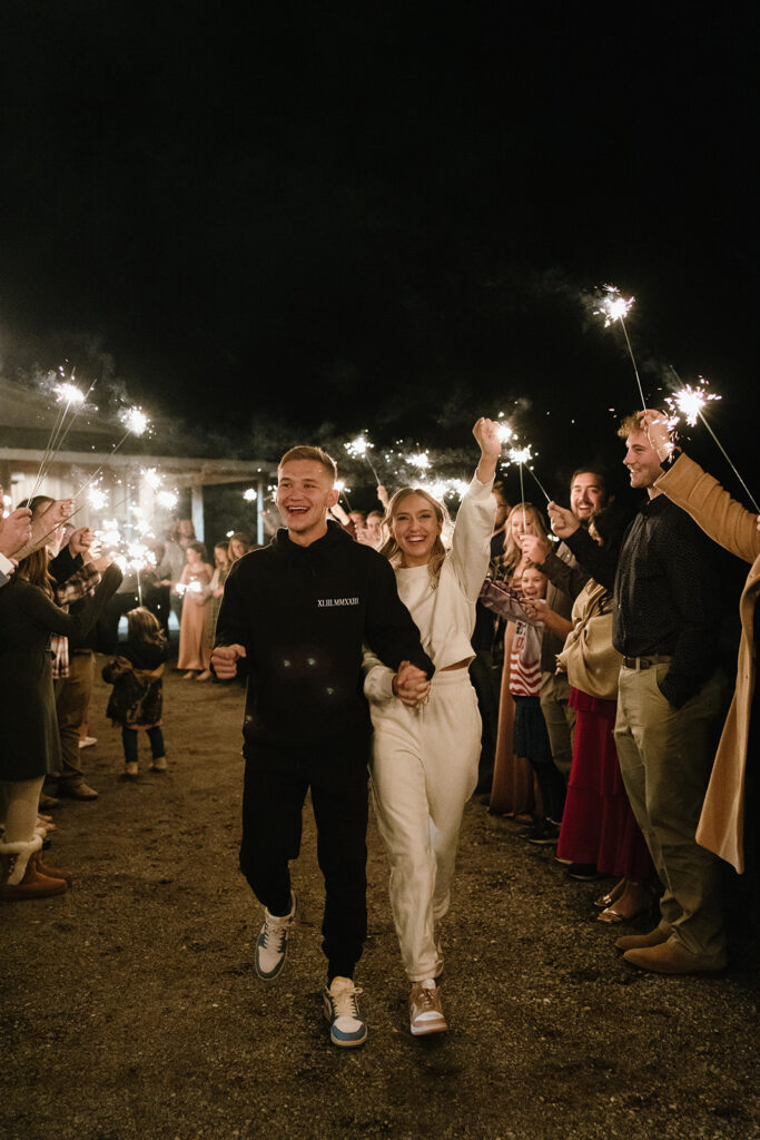 bride and groom walk through their sparkler exit