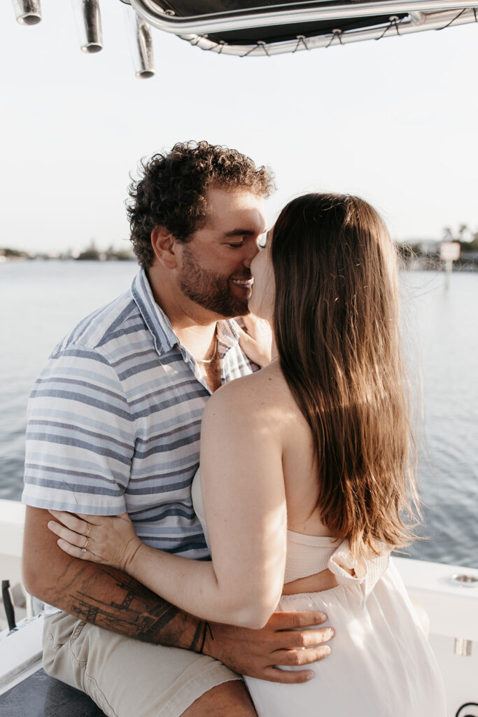 couple kissing on a boat in Florida