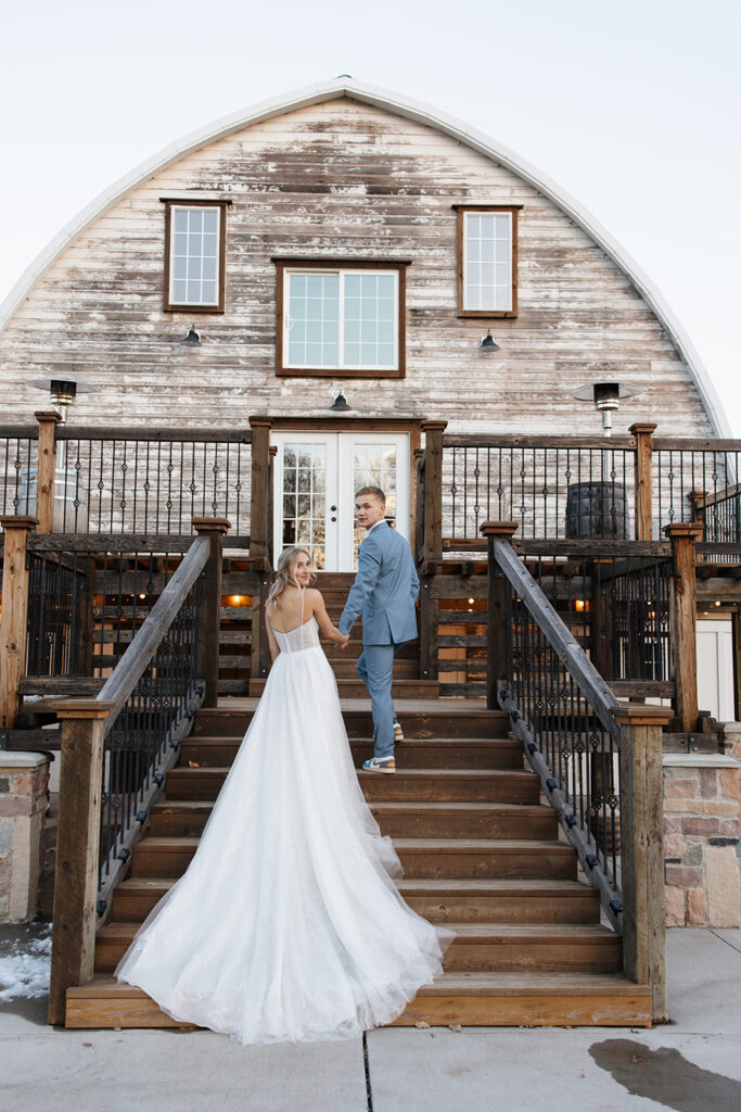 bride and groom standing outside of the Stone Hill Barn