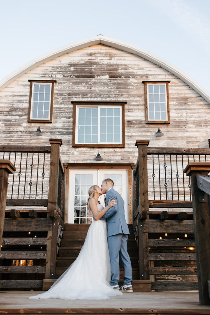 bride and groom standing outside of the Stone Hill Barn