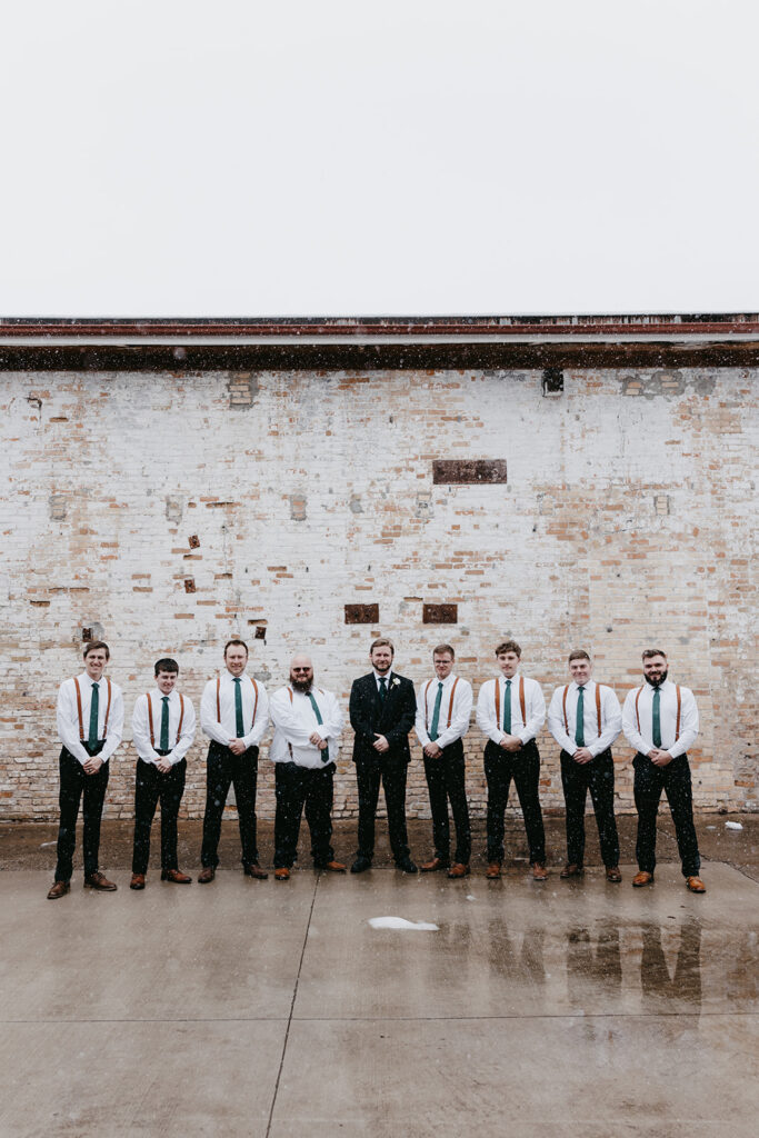 groom with groomsmen outside of the northern pacific center