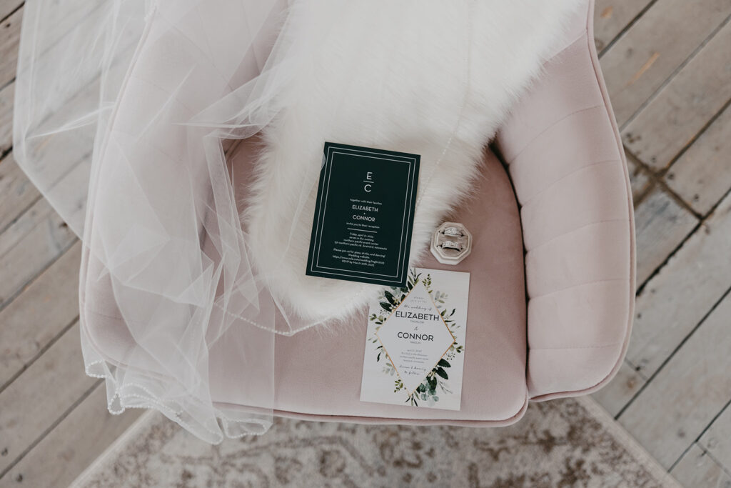 elegant wedding details flat lay on a pink velvet chair