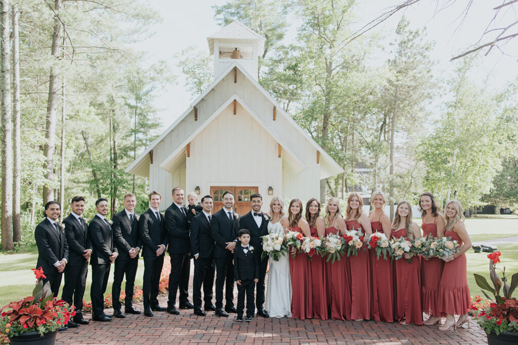 Wedding party standing in front of the Grand View Lodge chapel