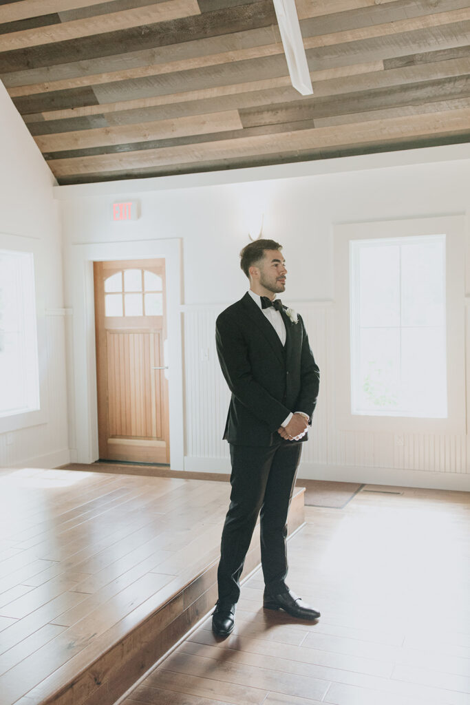 Groom watching his bride walk down the aisle