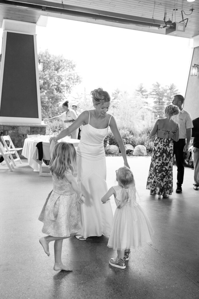 Bride dancing with two little girls