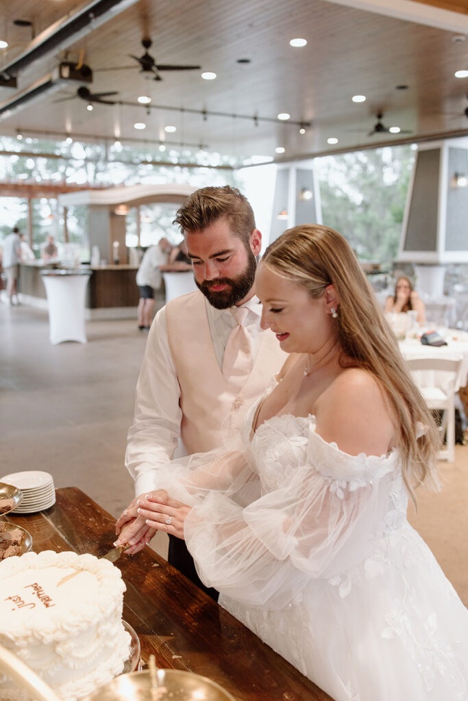 bride and groom cutting their wedding cake