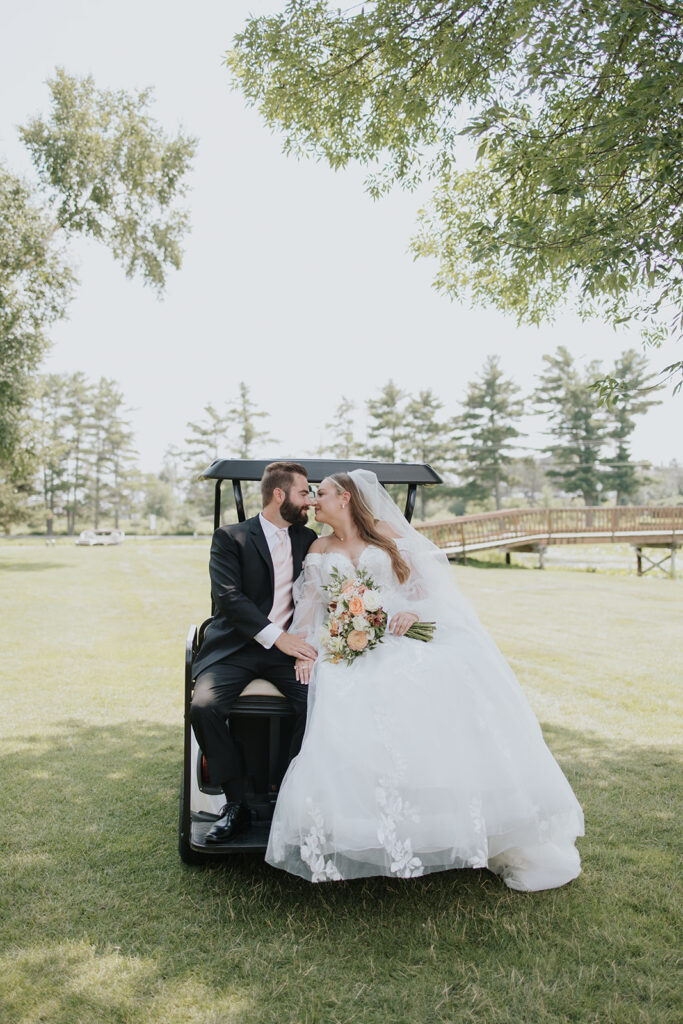 Bride and groom sitting on a golf cart