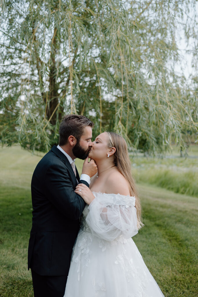 Bride and groom photos on the lawn at Madden's on Gull Lake