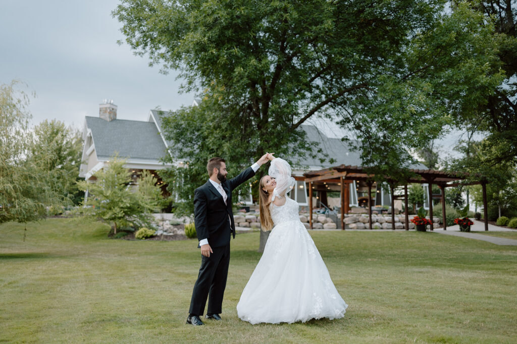 Bride and groom photos on the lawn at Madden's on Gull Lake