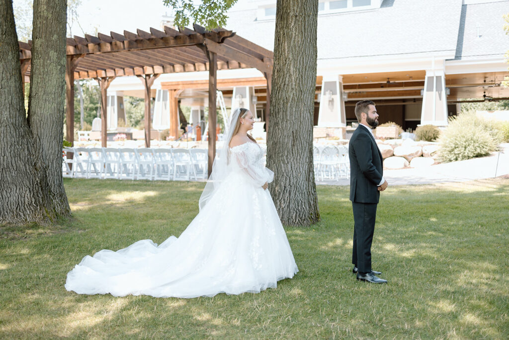 Bride and groom first look on the lawn at Madden's on Gull Lake