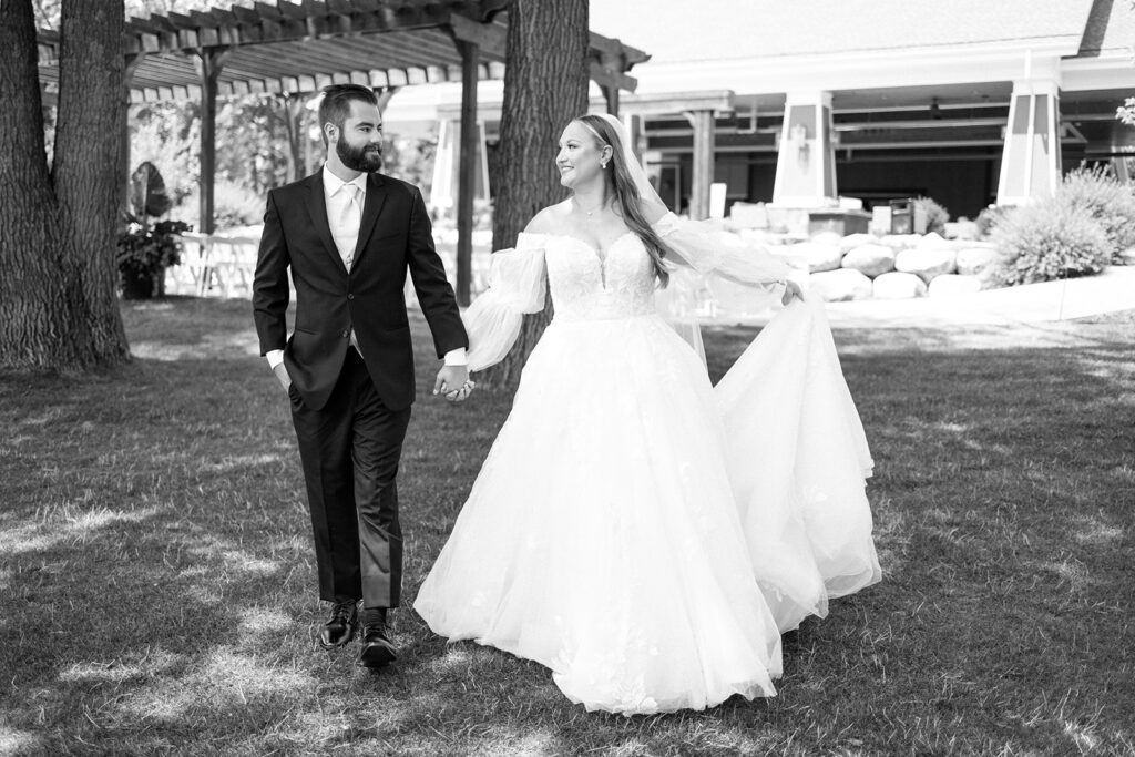 Bride and groom photos on the lawn at Madden's on Gull Lake