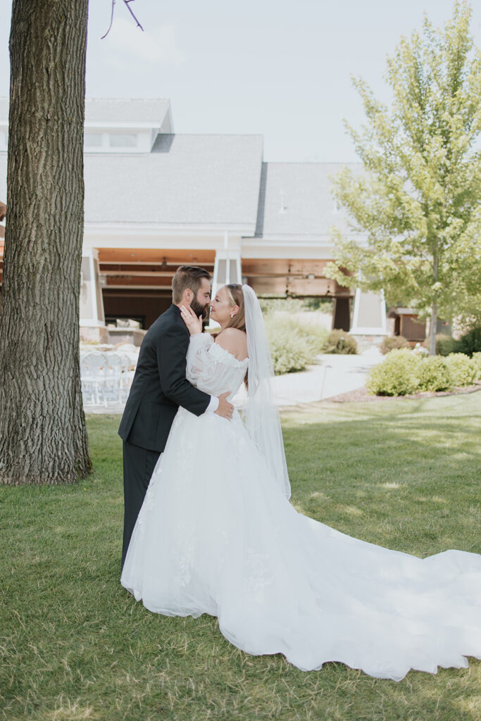 Bride and groom photos on the lawn at Madden's on Gull Lake