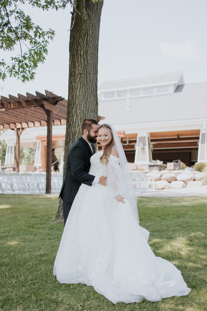 Bride and groom photos on the lawn at Madden's on Gull Lake