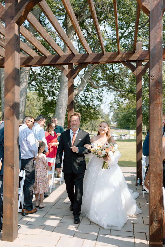 bride walking down the aisle with her father