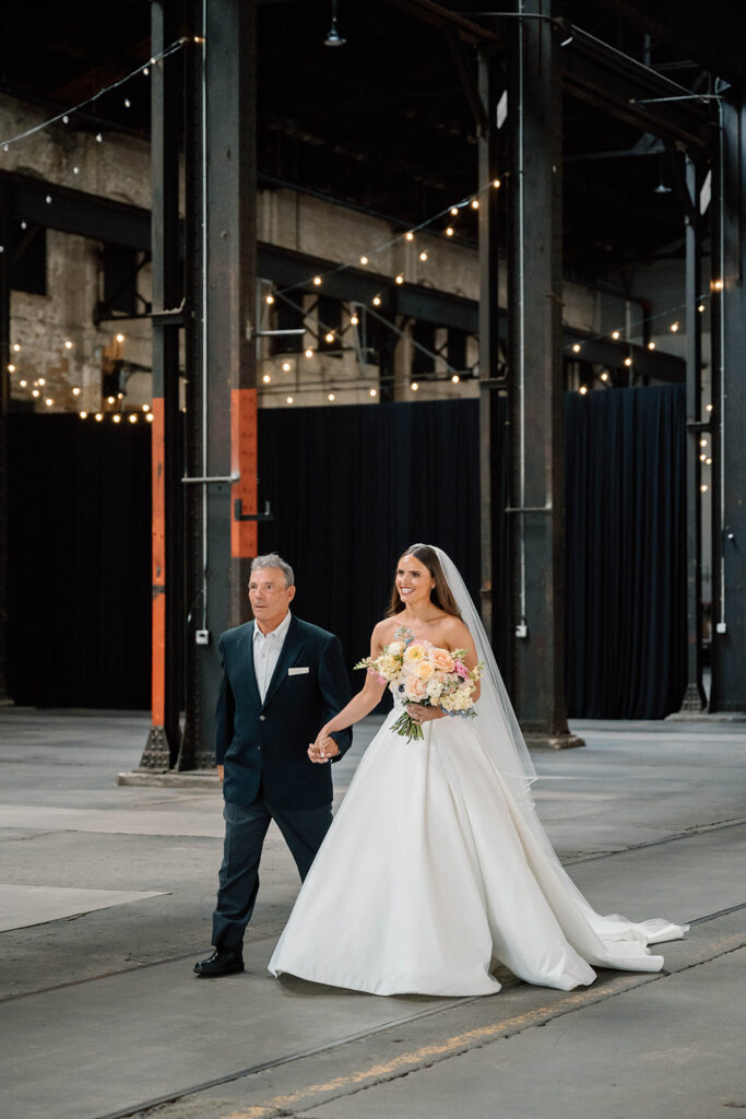 Elegant wedding ceremony setup inside The Northern Pacific Center with candles and florals