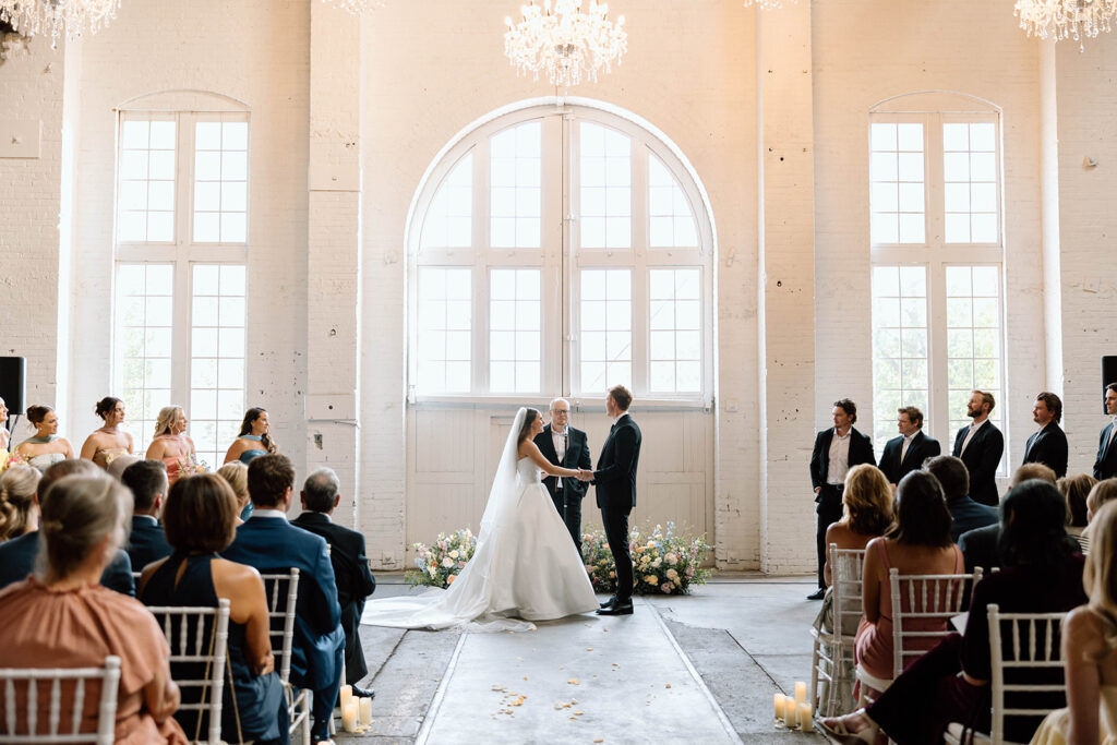 Elegant wedding ceremony setup inside The Northern Pacific Center with candles and florals
