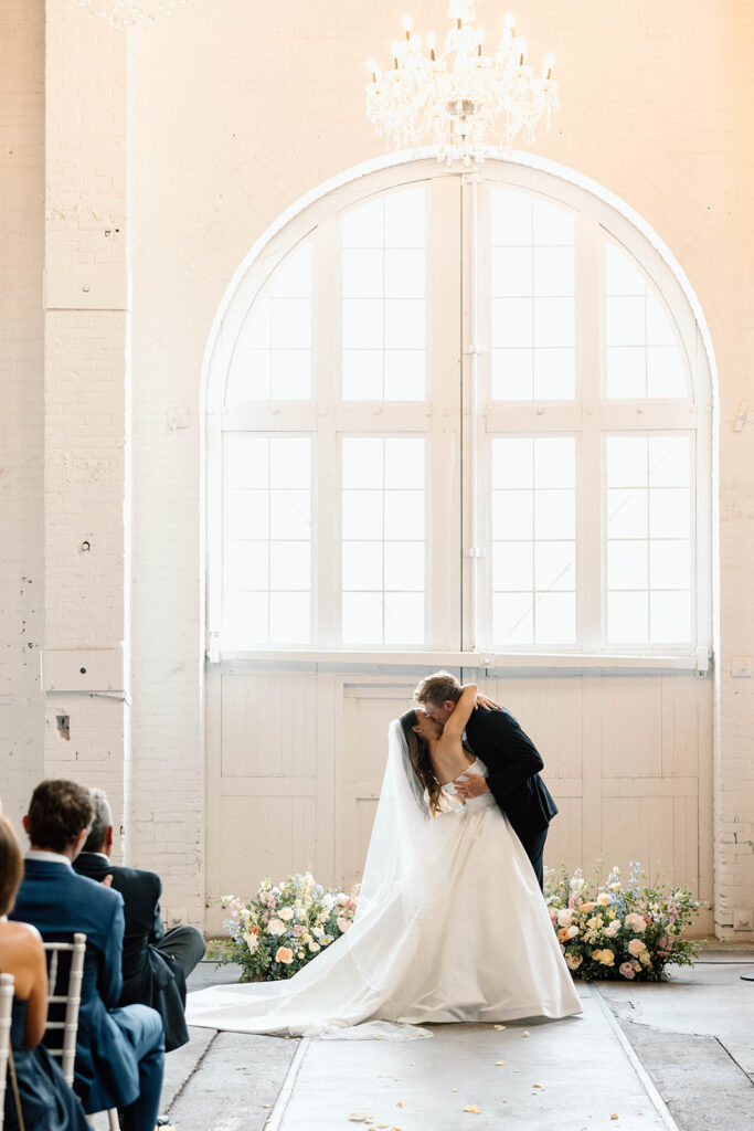 Elegant wedding ceremony setup inside The Northern Pacific Center with candles and florals
