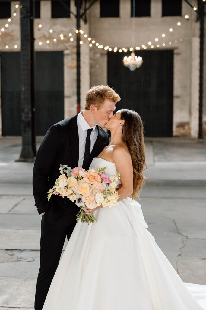 Bride and groom posing for timeless wedding portraits

