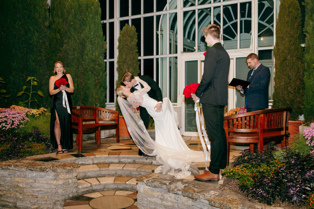 Candid photo taken during a cozy ceremony at a botanical space.
