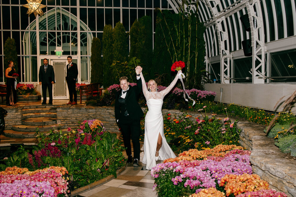 Candid photo taken during a cozy ceremony at a botanical space.
