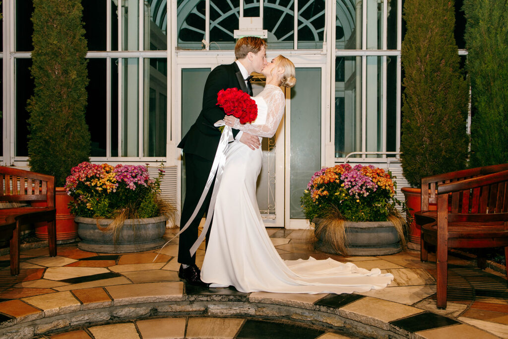 Candid photo taken during a cozy ceremony at a botanical space.
