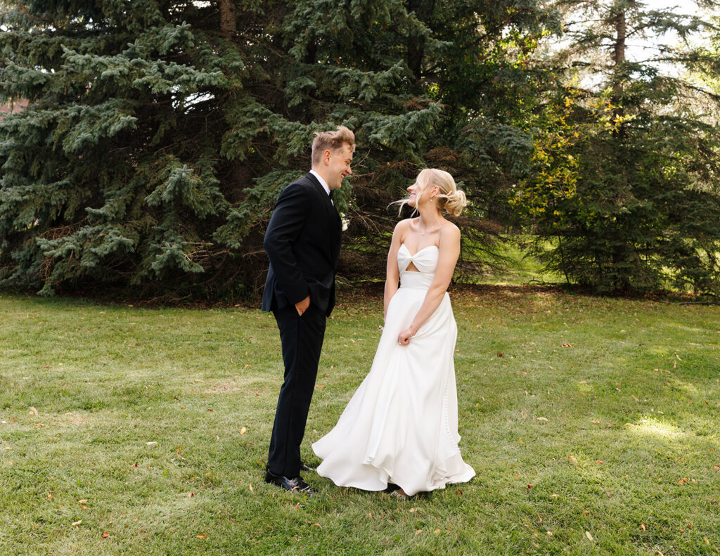 Bride’s dress blowing in the wind during romantic couple portraits