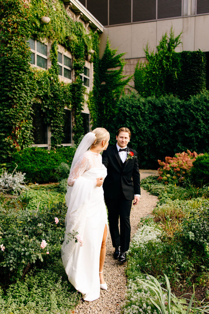 Candid photo taken during a cozy ceremony at a botanical space.
