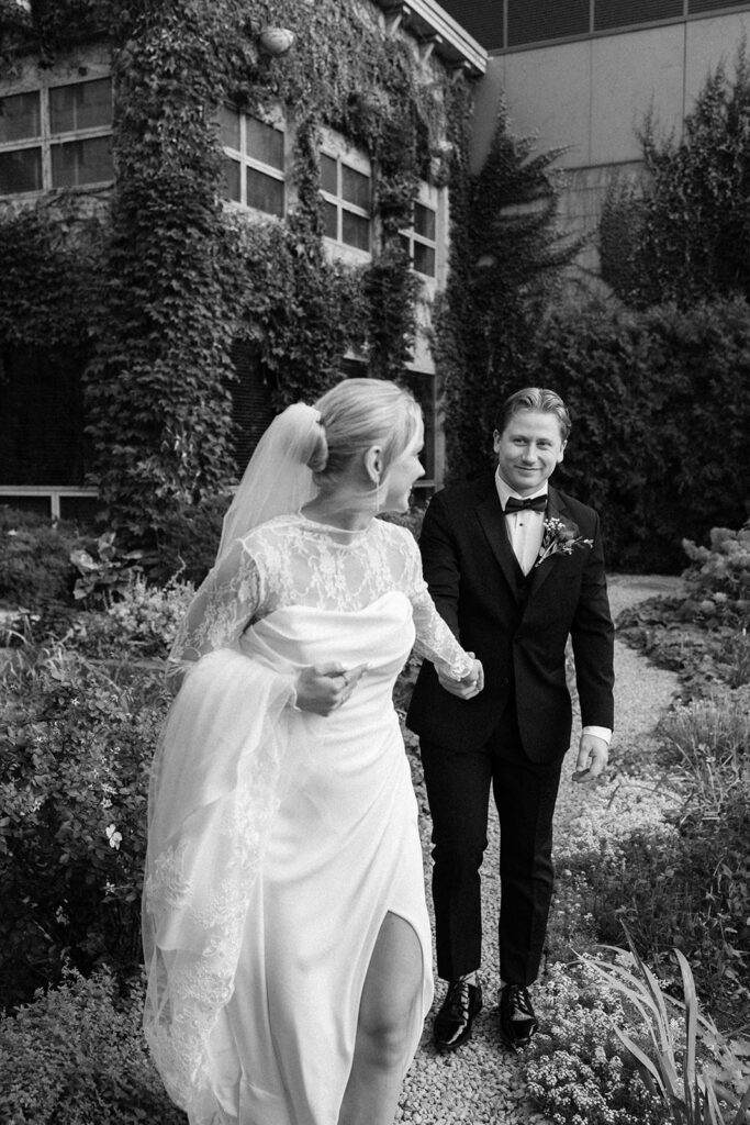 Candid photo taken during a cozy ceremony at a botanical space.
