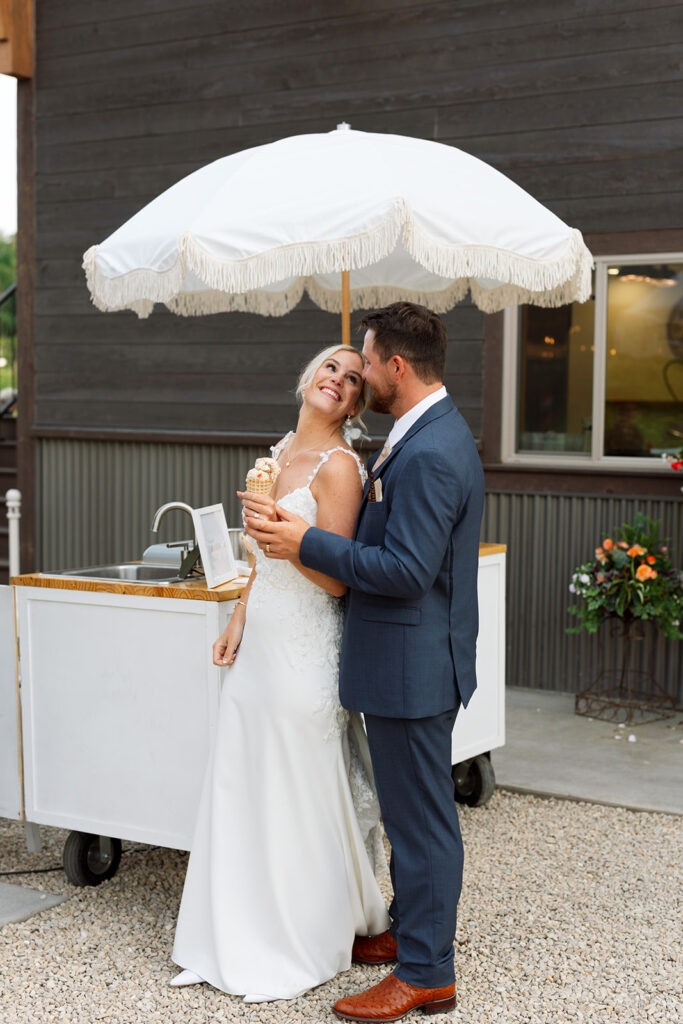 Bride and groom sharing a candid moment during their wedding day.
