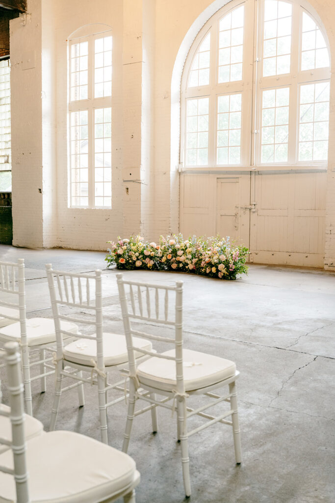 Elegant wedding ceremony setup inside The Northern Pacific Center with candles and florals
