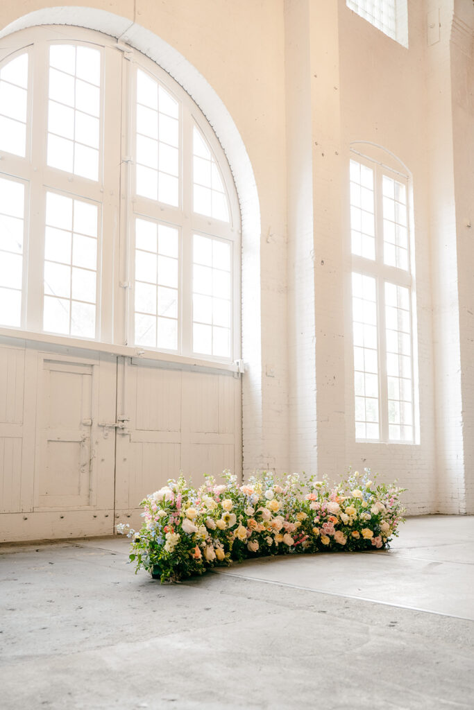 Elegant wedding ceremony setup inside The Northern Pacific Center with candles and florals
