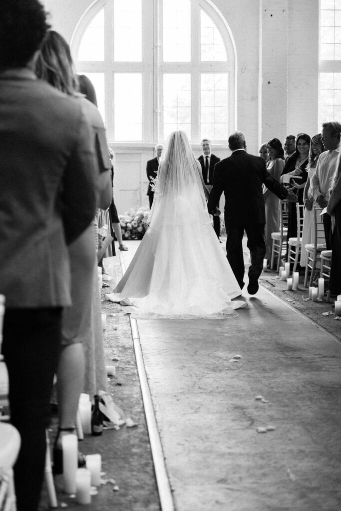 Elegant wedding ceremony setup inside The Northern Pacific Center with candles and florals
