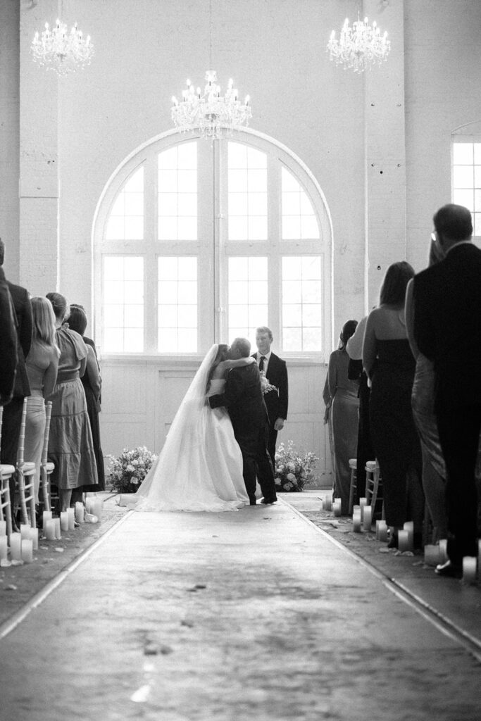Elegant wedding ceremony setup inside The Northern Pacific Center with candles and florals
