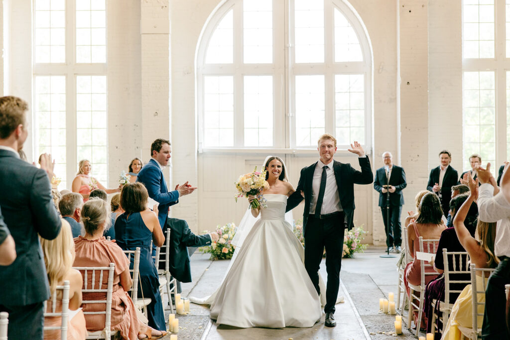 Elegant wedding ceremony setup inside The Northern Pacific Center with candles and florals
